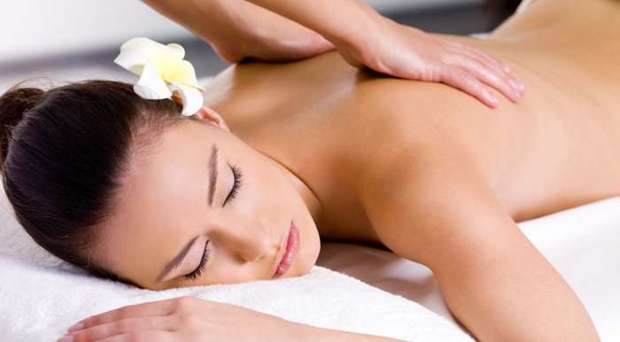 Beautiful woman having relaxing massage  in spa salon